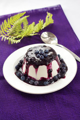 Sweet pudding with blueberry confiture