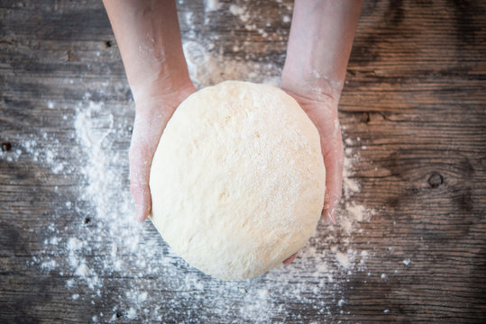 Hands holding the dough