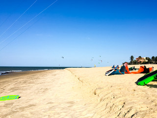 Fototapeta na wymiar Ocean, golden beach, kites and kite surfers off the north Brazilian coast