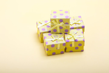 Fototapeta na wymiar Gift boxes with colored circles on a yellow background