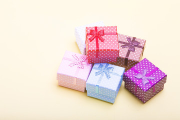 Group of colored Gift boxes with bows on a yellow background