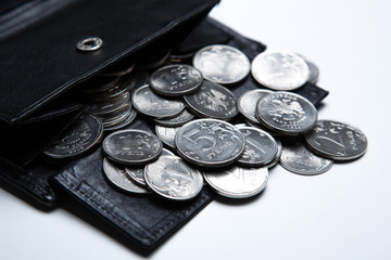 pocket purse with ruble coins on a white surface