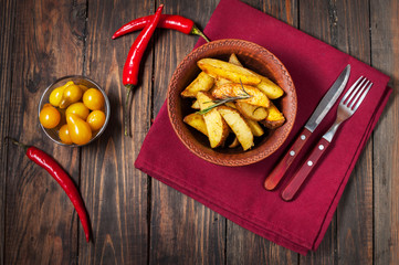 bowl of roasted potatoes with rosemary and tomatoes