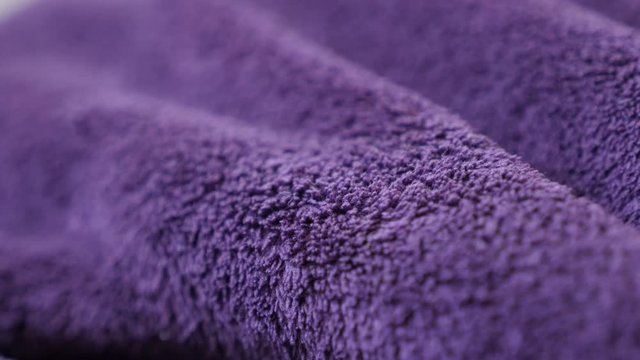 Decorative purple polar fleece close-up 4K 2160p 30fps UltraHD panning footage - Slow pan on synthetic fibers of warm violet blanket 3840X2160 UHD video 