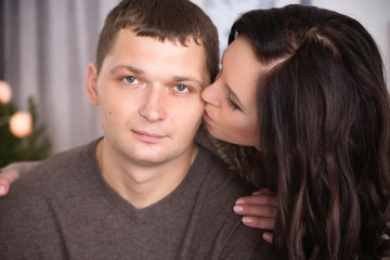 Tender wife kissing husband