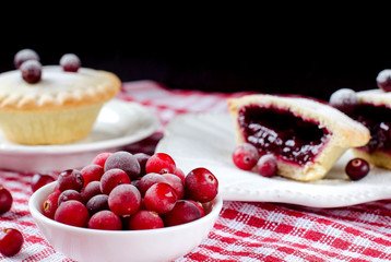 Pies with berries. Cranberries in a bowl.