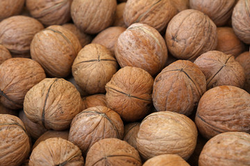 Whole walnuts in nutshells close up