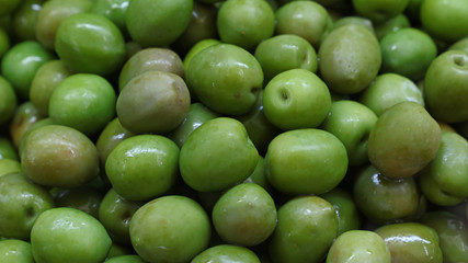 Green whole olives close up background