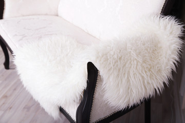 white sofa with fur bedspread
