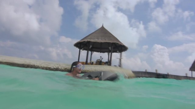 Fit Young Woman Drifting On Sea Surface With Small Jet