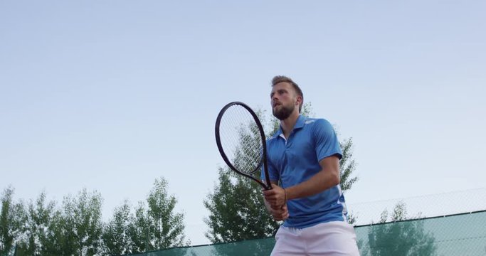  Low Angle Slow-Mo: Tennis Player Concentrates And Hits Forehand