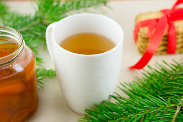 biscuits, apricot jam, cup of tea, pine needles on sacking