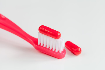 concept toothache with toothbrush and tablet at white background