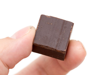 chocolate in his hand on a white background