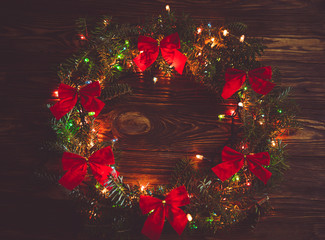 Tradition Christmas wreath on wooden background. Dark toned  war