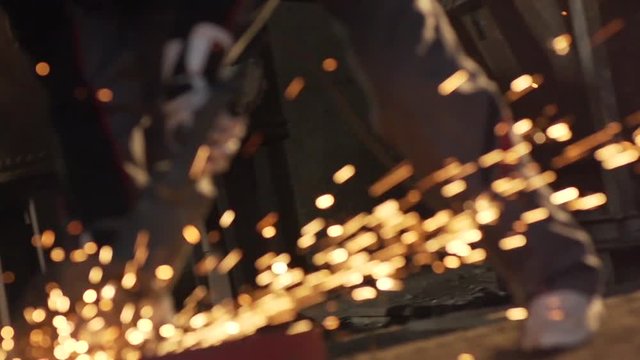 Handheld Shot Of Professional Workers Cutting