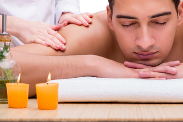 Fototapeta na wymiar Handsome man during spa massaging session