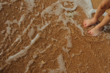 legs of child on the sand beach red sea nice tropical view