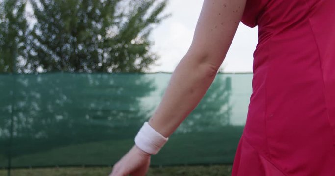 Female Tennis Player Throws The Ball To Serve
