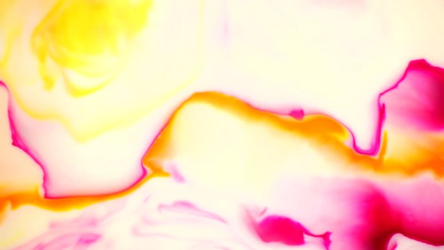 Liquid ink two colors yellow and magenta blending burst swirl fluid