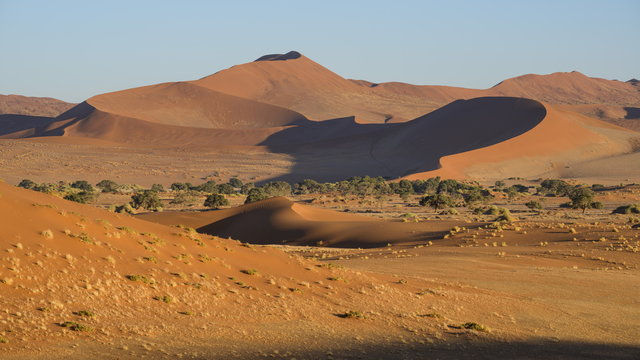 Looking towards the dunes of Sossusvlei, with two tiny figures on the lower ridge of the dune, Namib Naukluft, Namibia
