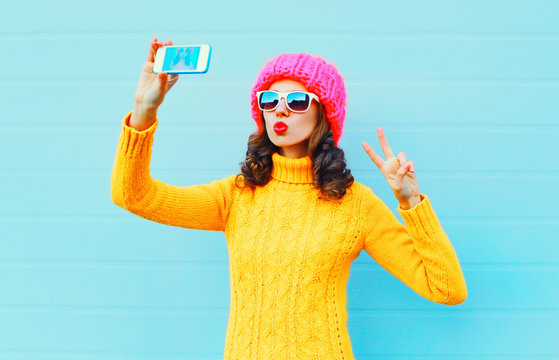 Fashion young woman taking picture self portrait on smartphone o