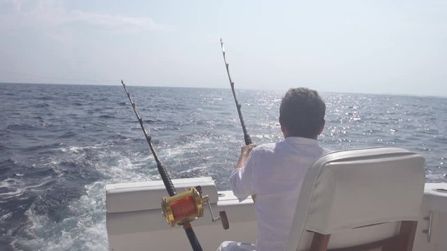 Man Placing Rod For Big Game Fishing