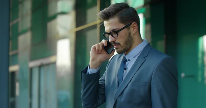 Business Man Receives Serious Information Through The Mobile Phone