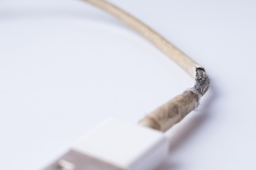 Closeup the Broken Smart Phone Charger Cable on white Background