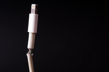 Closeup the Broken Smart Phone Charger Cable on black Background