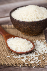 Fototapeta na wymiar White Thai jasmine rice on wooden plank