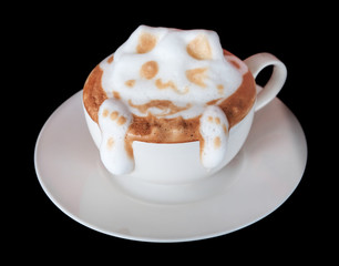 Cup of art latte or cappuccino coffee isolated on black.