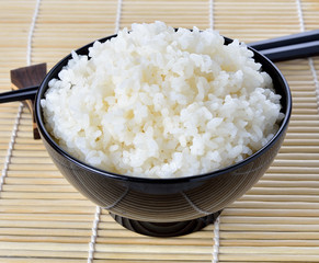 White steamed rice in black round bowl