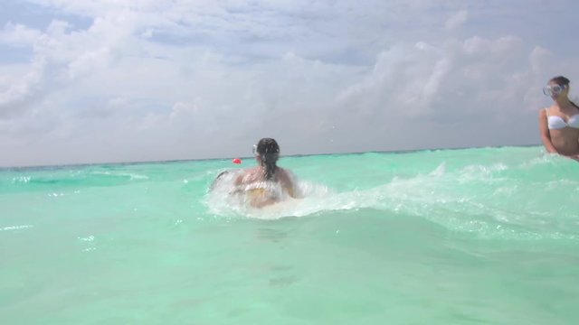 Woman Watching Her Best Friend Surfing With Small Jet