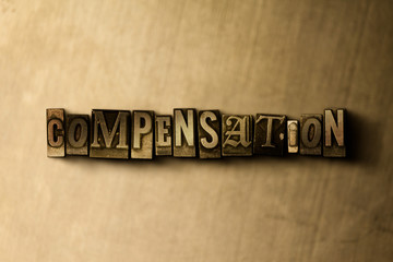 COMPENSATION - close-up of grungy vintage typeset word on metal backdrop. Royalty free stock illustration.  Can be used for online banner ads and direct mail.