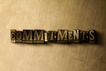 COMMITMENTS - close-up of grungy vintage typeset word on metal backdrop. Royalty free stock illustration.  Can be used for online banner ads and direct mail.