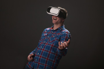 Young Caucasian man playing guitar with virtual reality headset