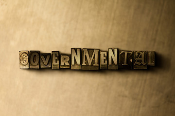 Naklejka premium GOVERNMENTAL - close-up of grungy vintage typeset word on metal backdrop. Royalty free stock illustration. Can be used for online banner ads and direct mail.