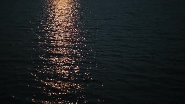 Moonlight path with low fool moon above the river at night
