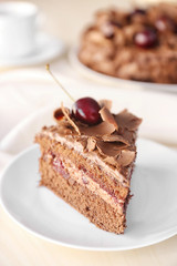 Delicious chocolate cake with cherry on plate