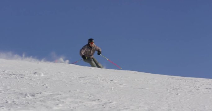 Slow Motion  Of Skier Enjoying Holidays Skiing On Sunny Winter Day