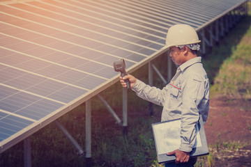 engineer working on checking and maintenance equipment in solar power plant