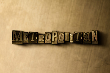 METROPOLITAN - close-up of grungy vintage typeset word on metal backdrop. Royalty free stock illustration.  Can be used for online banner ads and direct mail.