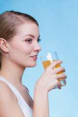 Woman drinking orange flavored drink or juice