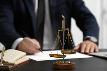 Scales of justice on table, closeup