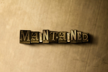 Naklejka premium MAINTAINED - close-up of grungy vintage typeset word on metal backdrop. Royalty free stock illustration. Can be used for online banner ads and direct mail.