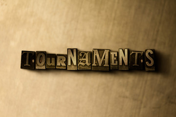 Naklejka premium TOURNAMENTS - close-up of grungy vintage typeset word on metal backdrop. Royalty free stock illustration. Can be used for online banner ads and direct mail.