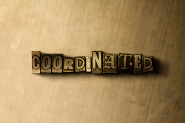 COORDINATED - close-up of grungy vintage typeset word on metal backdrop. Royalty free stock illustration.  Can be used for online banner ads and direct mail.