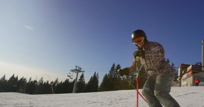 Beautiful Sun Flared Slow Motion  Of Skier Carving Down The Ski Slope