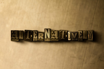 ALTERNATIVELY - close-up of grungy vintage typeset word on metal backdrop. Royalty free stock illustration.  Can be used for online banner ads and direct mail.